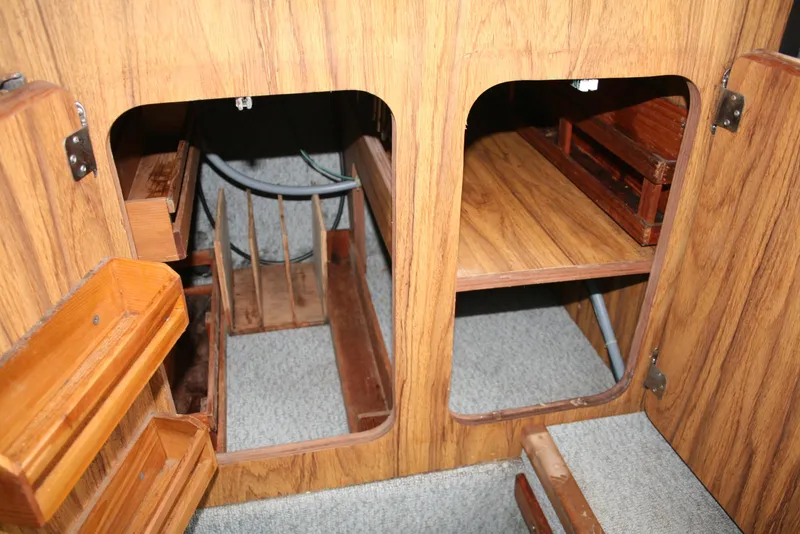 Slide: The Image of Interior storage compartments of a 1991 Olympic 23' Runabout boat. - 13