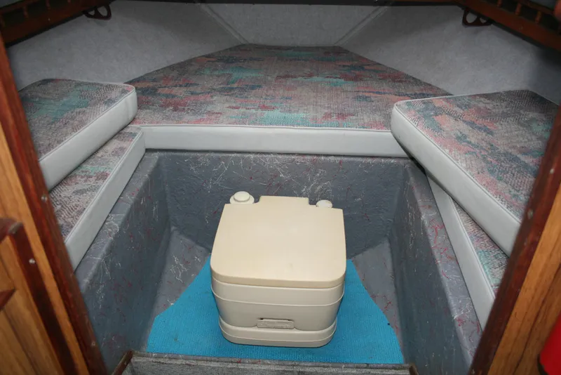 Slide: The Image of Interior cabin of a 1991 Olympic 23' Runabout boat with portable toilet. - 15