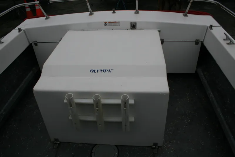 Slide: The Image of 1991 Olympic 23' Runabout boat interior with storage compartment and rod holders. - 17