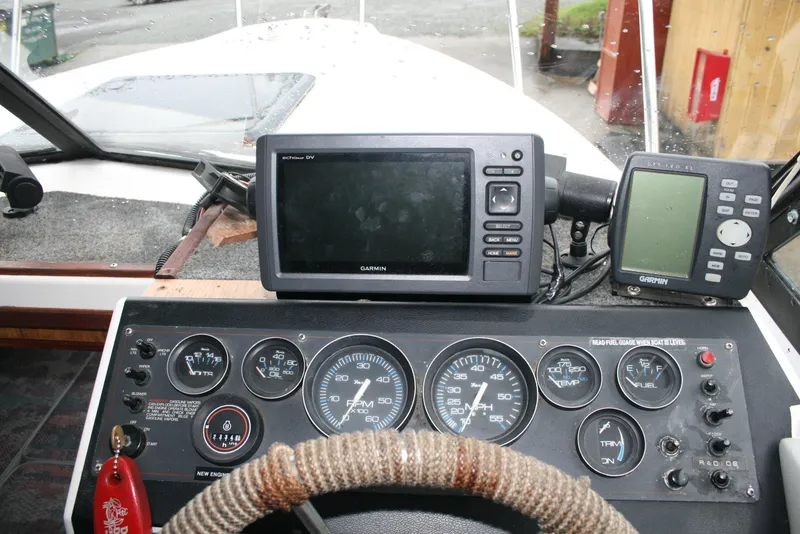Slide: The Image of Dashboard of a 1991 Olympic 23' Runabout boat with Garmin navigation equipment. - 3