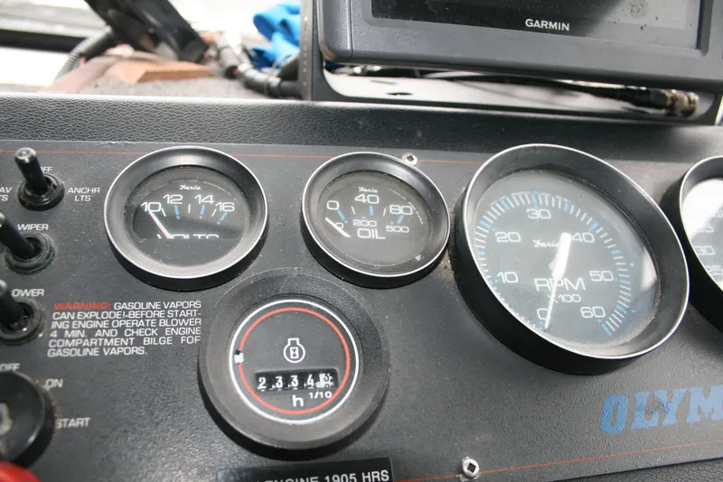 Slide: The Image of Dashboard of a 1991 Olympic 23' Runabout boat with gauges and Garmin device. - 4