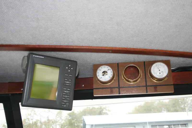 Slide: The Image of 1991 Olympic 23' Runabout dashboard with navigation equipment and gauges. - 6