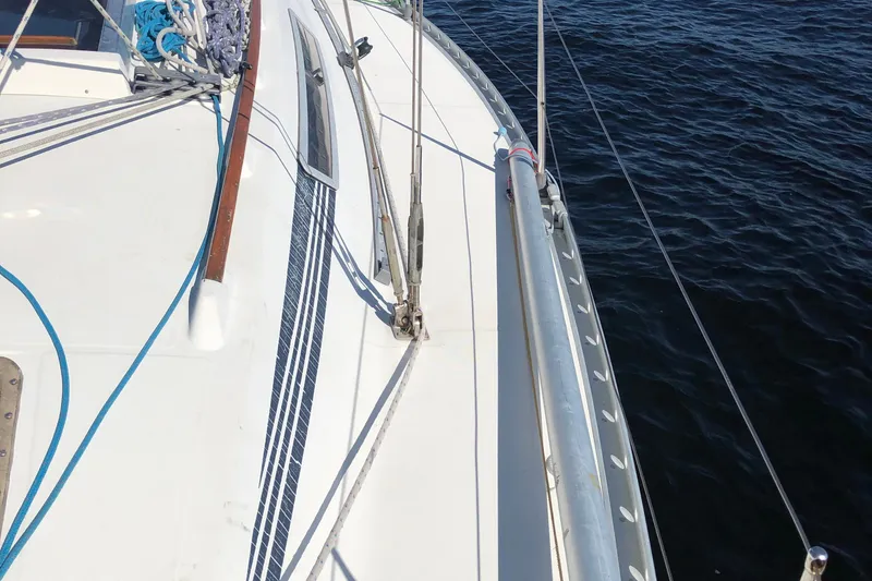 Slide: The Image of Deck view of 1985 Beneteau First 345 sailboat on calm water. - 28