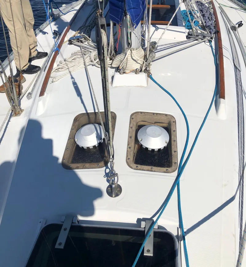 Slide: The Image of 1985 Beneteau First 345 sailboat deck with ropes and hatches. - 29