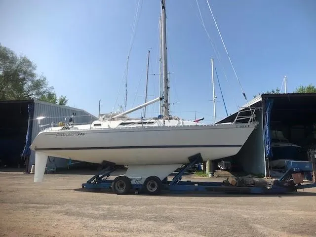 Slide: The Image of 1985 Beneteau First 345 sailboat on trailer in marina yard. - 44