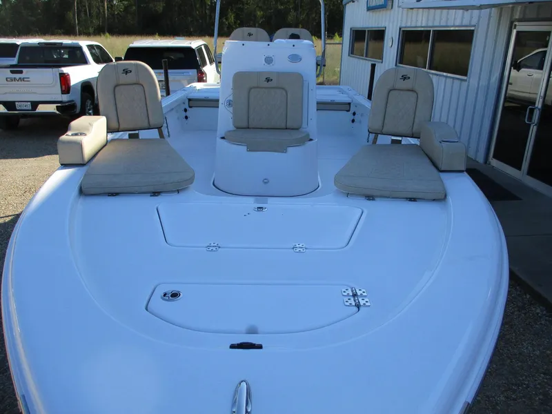 Slide: The Image of 2024 Sea Pro 228 DLX Bay boat with cushioned seating and storage compartments. - 11