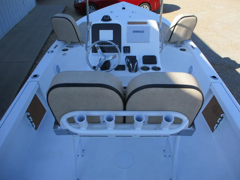 Slide: The Image of 2024 Sea Pro 228 DLX Bay boat interior with dual seats and steering console. - 12