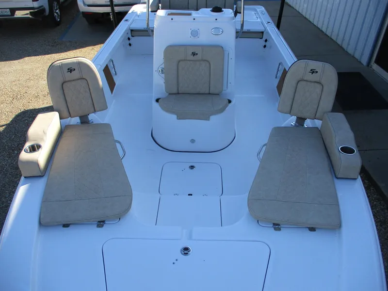 Slide: The Image of 2024 Sea Pro 228 DLX Bay boat interior with beige seating and white deck. - 14