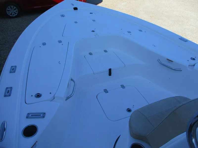 Slide: The Image of 2024 Sea Pro 228 DLX Bay boat deck with storage compartments and seating. - 15