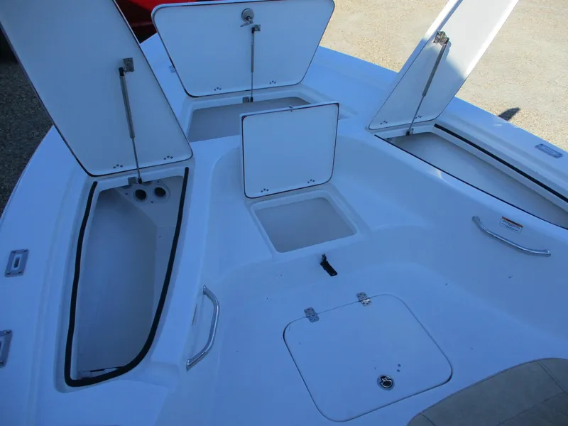 Slide: The Image of 2024 Sea Pro 228 DLX Bay boat with open storage compartments. - 16