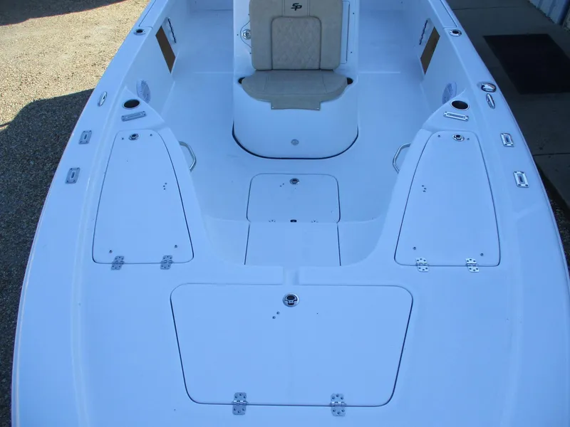 Slide: The Image of 2024 Sea Pro 228 DLX Bay boat interior with storage compartments and seating. - 17