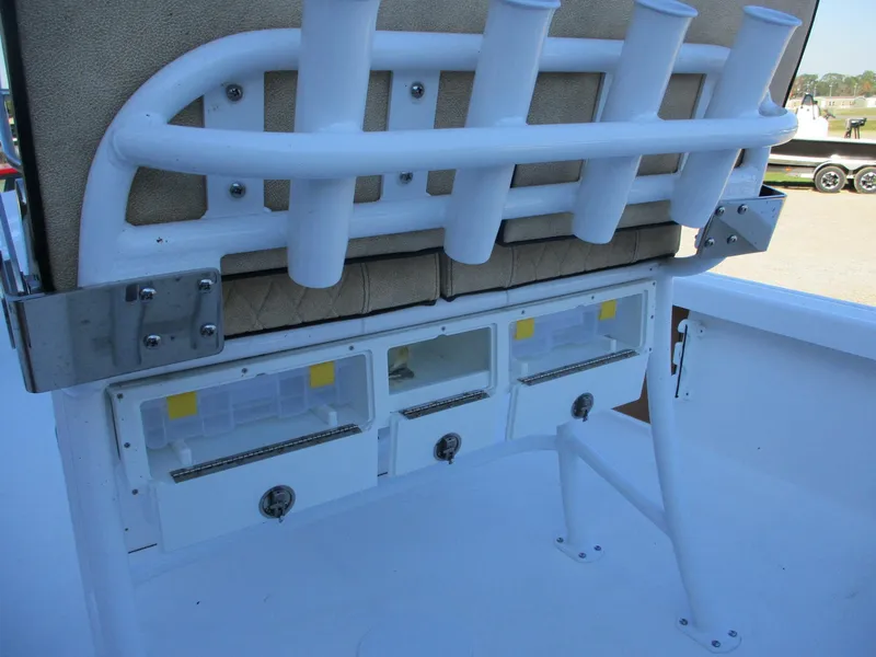 Slide: The Image of 2024 Sea Pro 228 DLX Bay boat with rod holders and storage compartments. - 6