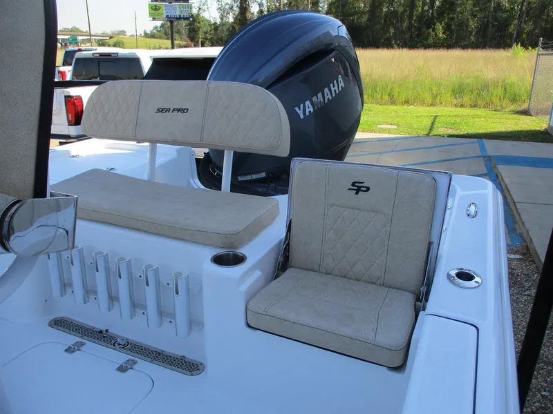 Slide: The Image of 2024 Sea Pro 228 DLX Bay boat with Yamaha engine, rear seating and rod holders. - 7