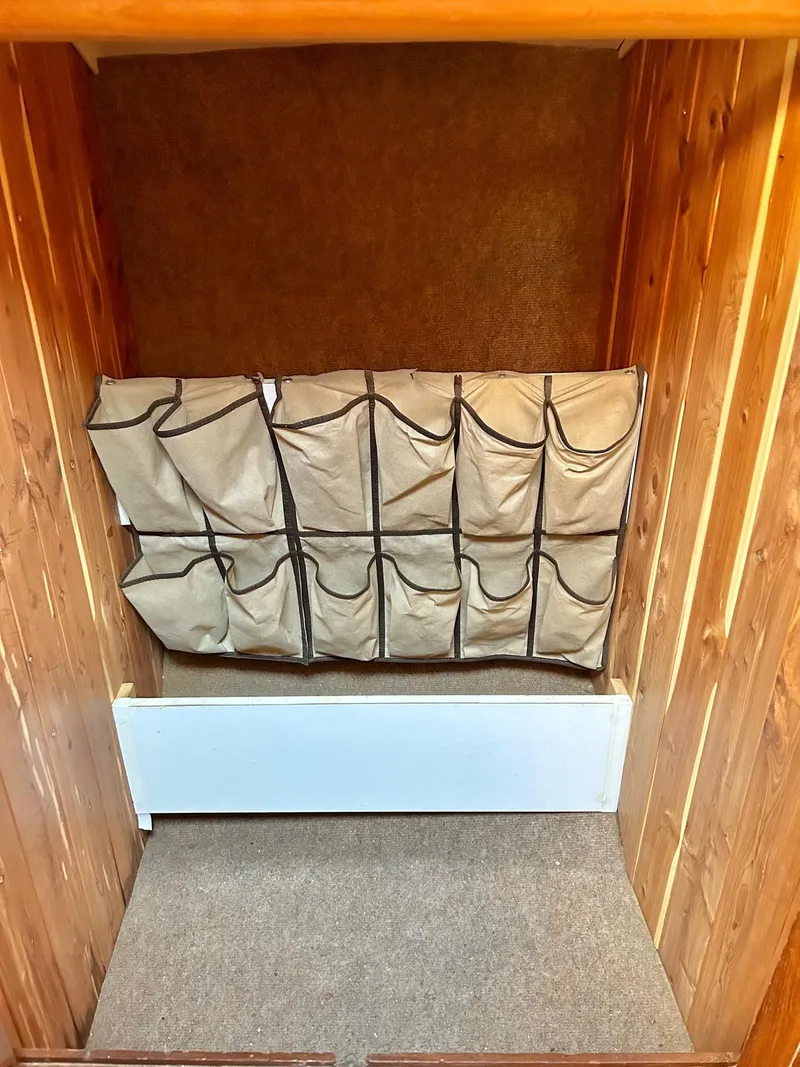 Slide: The Image of Storage area with hanging organizer in a 1975 Salar 40 boat interior. - 11