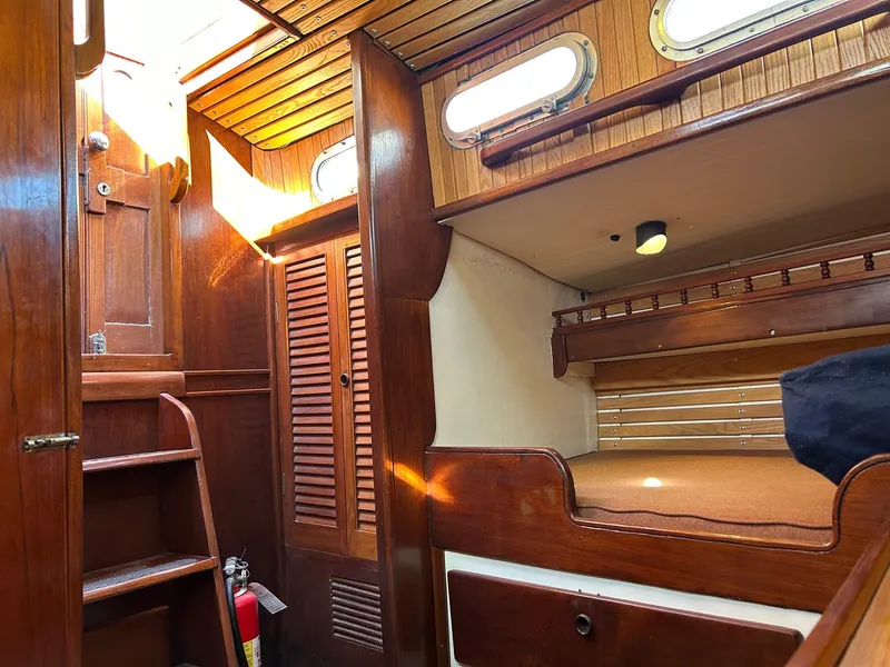 Slide: The Image of Interior of a 1975 Salar 40 sailboat with wooden furnishings and cozy cabin space. - 14