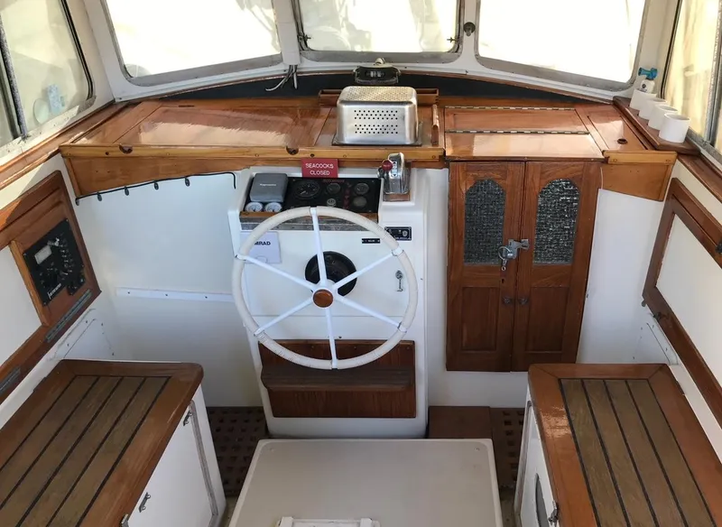 Slide: The Image of Interior of a 1975 Salar 40 boat, featuring a wooden helm and seating. - 20