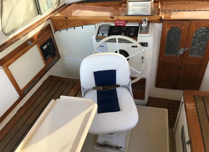 Slide: The Image of Interior of a 1975 Salar 40 boat, featuring a steering wheel and captain's chair. - 25