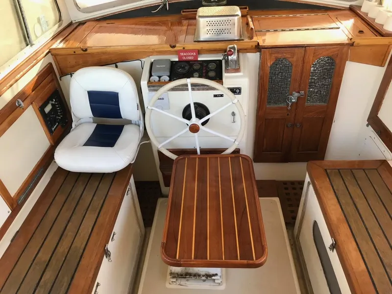 Slide: The Image of Interior of a 1975 Salar 40 boat with wooden accents and steering wheel. - 30