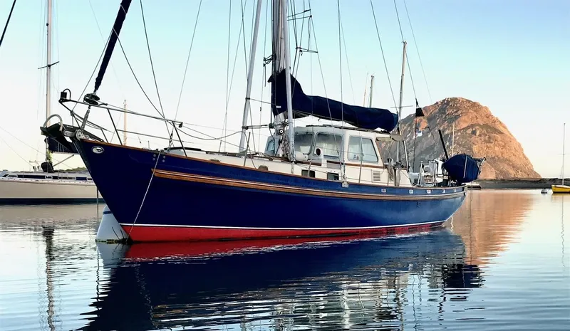 Slide: The Image of Salar 40 sailboat from 1975 on calm water with mountain backdrop. - 35