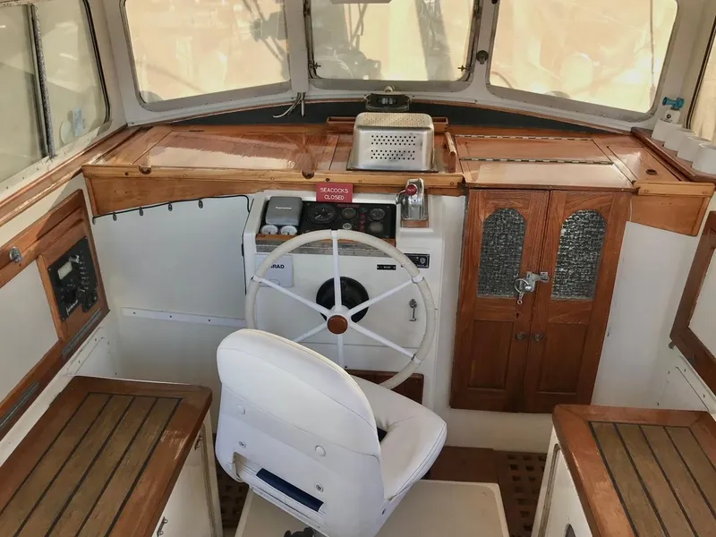 Slide: The Image of Interior of a 1975 Salar 40 boat cockpit with wooden accents and steering wheel. - 36