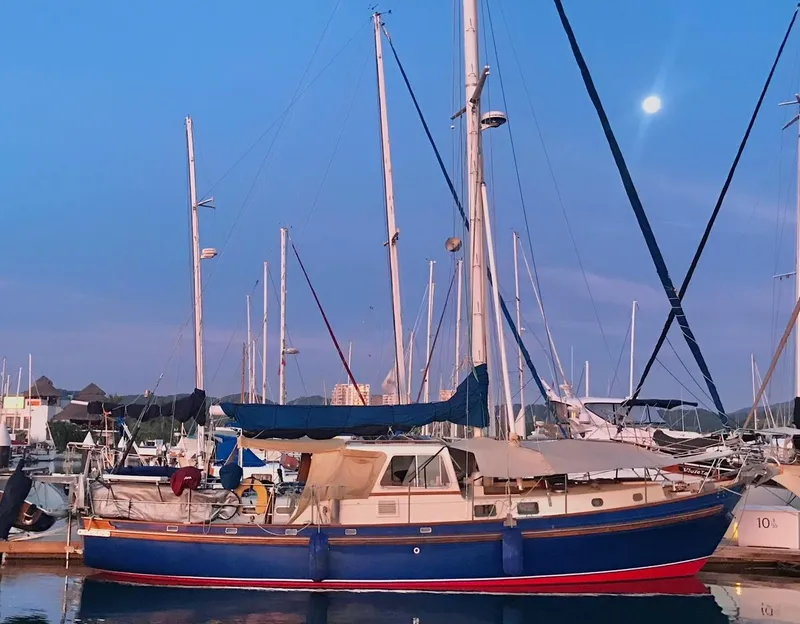 Slide: The Image of Salar 40 sailboat from 1975 docked at a marina during sunset. - 37