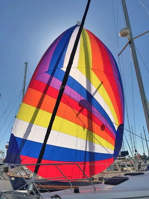 Slide: The Image of Colorful spinnaker sail on a 1975 Salar 40 yacht against a clear blue sky. - 39