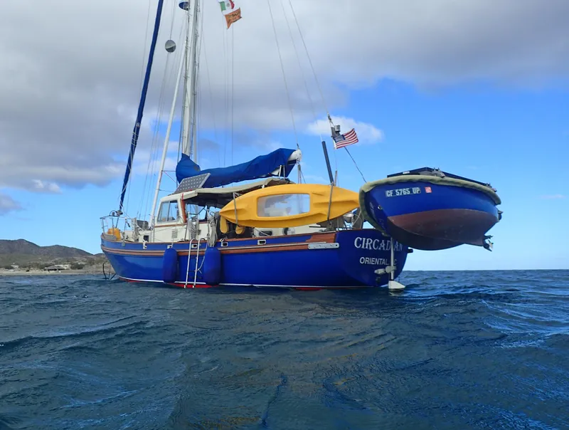 Slide: The Image of Salar 40 sailboat from 1975 on open water, featuring blue hull and yellow canopy. - 42