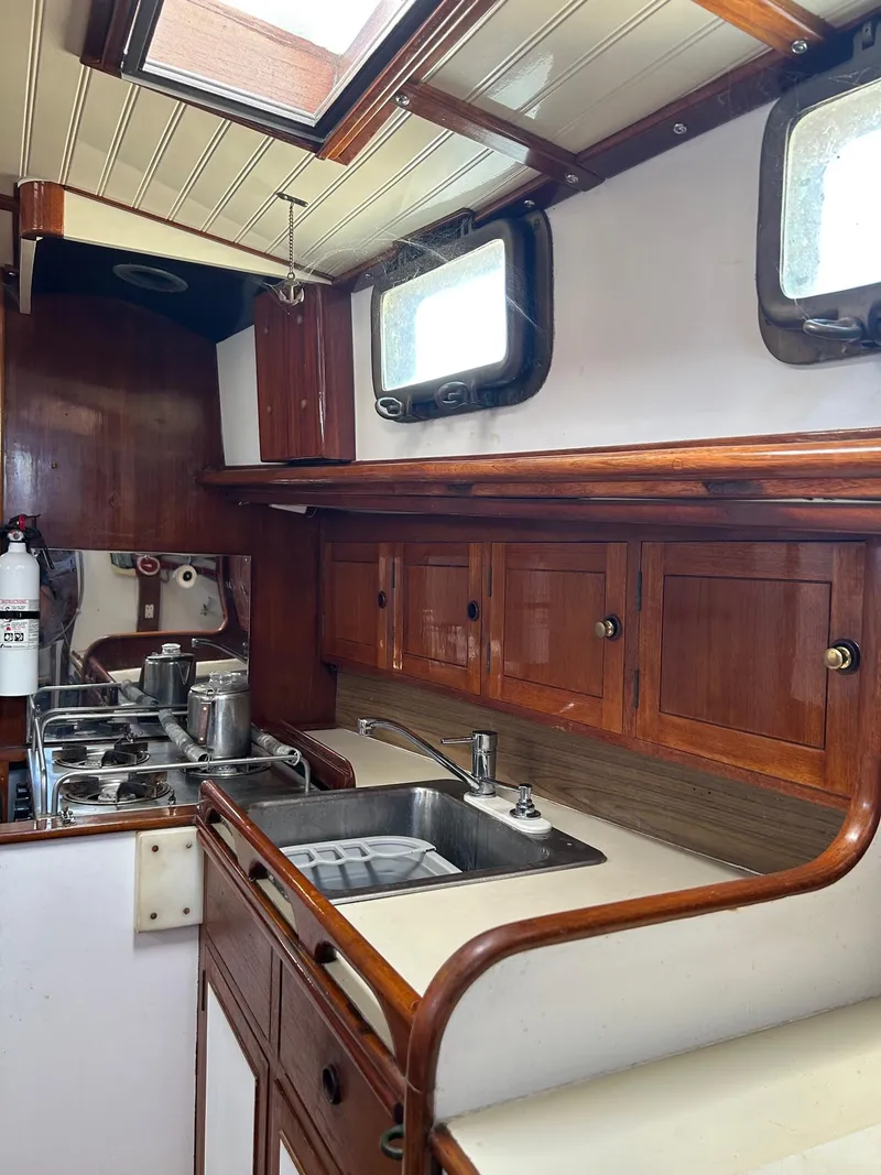 Slide: The Image of 1975 Salar 40 yacht kitchen with wooden cabinets and stainless steel sink. - 5