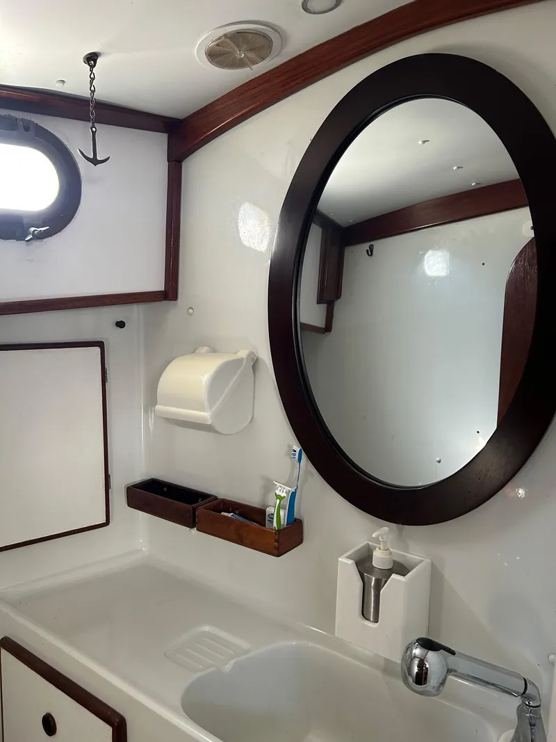 Slide: The Image of Vintage 1975 Salar 40 yacht bathroom with oval mirror and wooden accents. - 7