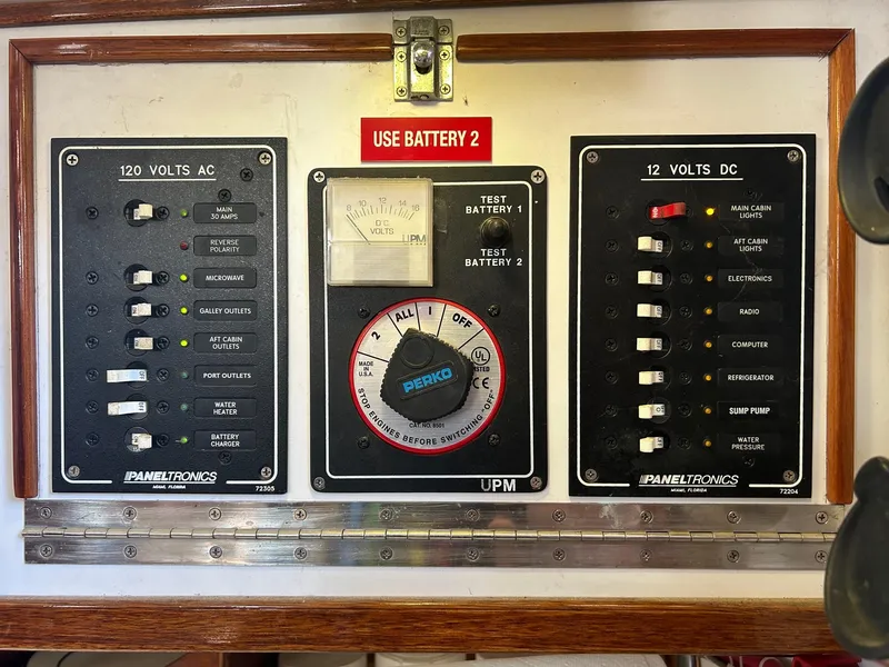 Slide: The Image of Electrical control panel on a 1975 Salar 40 boat, featuring AC and DC switches. - 8