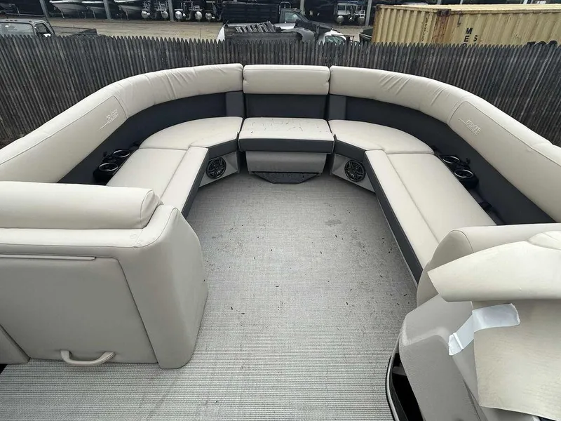 Slide: The Image of 2024 Harris Cruiser 230 boat interior with beige seating and cup holders. - 3