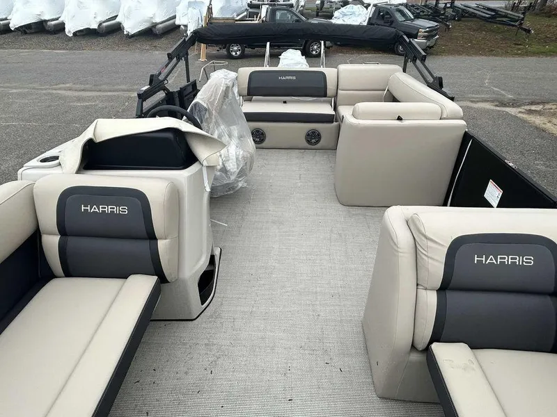 Slide: The Image of 2024 Harris Cruiser 230 pontoon boat interior with beige seating and spacious layout. - 4