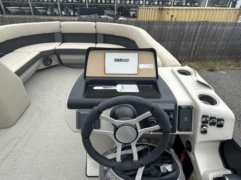 Slide: The Image of 2024 Harris Cruiser 230 boat interior with steering wheel and Simrad navigation system. - 5