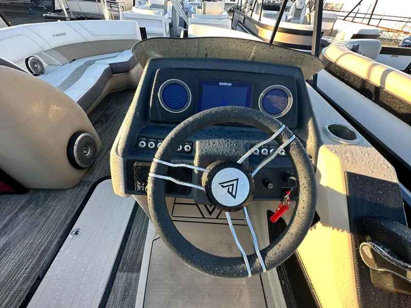 Slide: The Image of 2023 Viaggio Diamante S boat steering console with modern dashboard and seating area. - 11