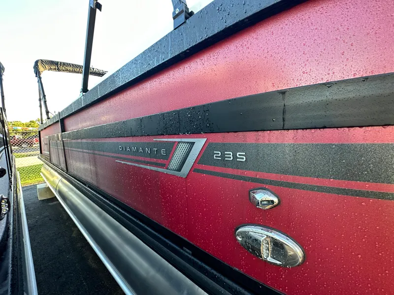 Slide: The Image of 2023 Viaggio Diamante S 235 pontoon boat, red exterior with black accents. - 3