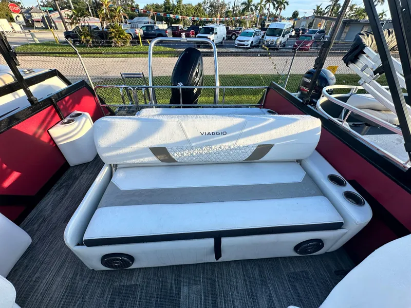 Slide: The Image of 2023 Viaggio Diamante S boat interior with white cushioned seating and cup holders. - 9