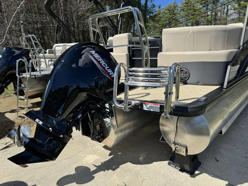 Slide: The Image of 2024 Harris Cruiser 210 pontoon boat with Mercury outboard motor, rear view. - 3