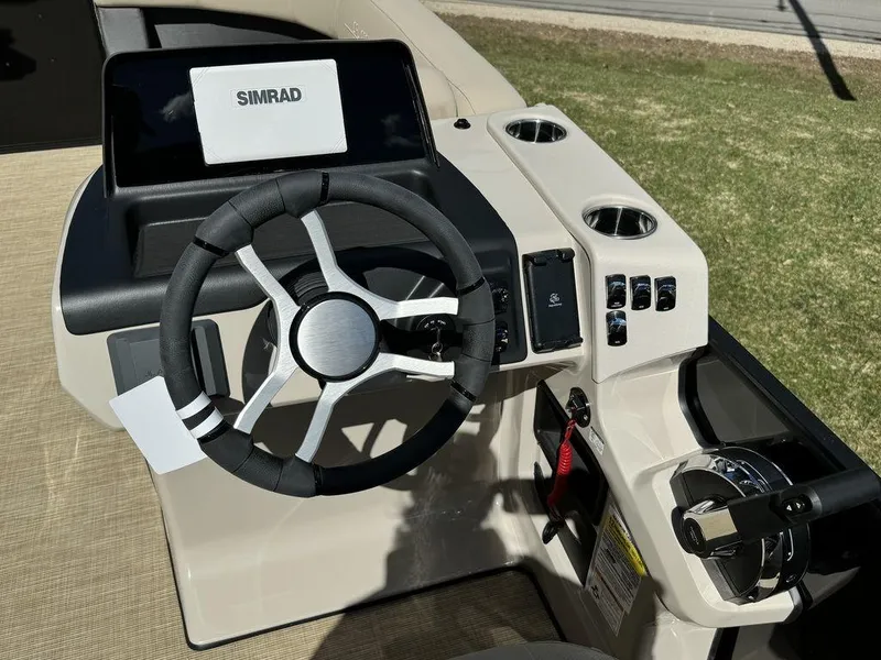 Slide: The Image of 2024 Harris Cruiser 210 boat dashboard with Simrad display and steering wheel. - 4