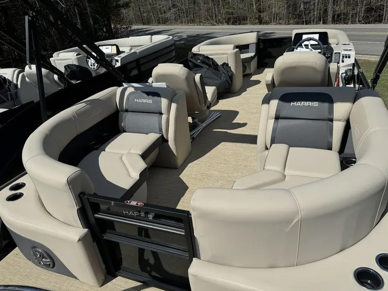 Slide: The Image of 2024 Harris Cruiser 210 pontoon boat with beige and gray seating. - 5