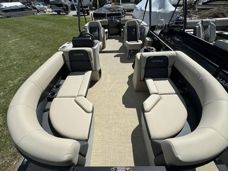 Slide: The Image of 2024 Harris Cruiser 210 pontoon boat with spacious seating and modern design. - 6