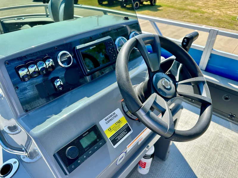 Slide: The Image of 2023 Tahoe Pontoon 23FT Sport 85 Center Console Fish dashboard and steering wheel. - 6