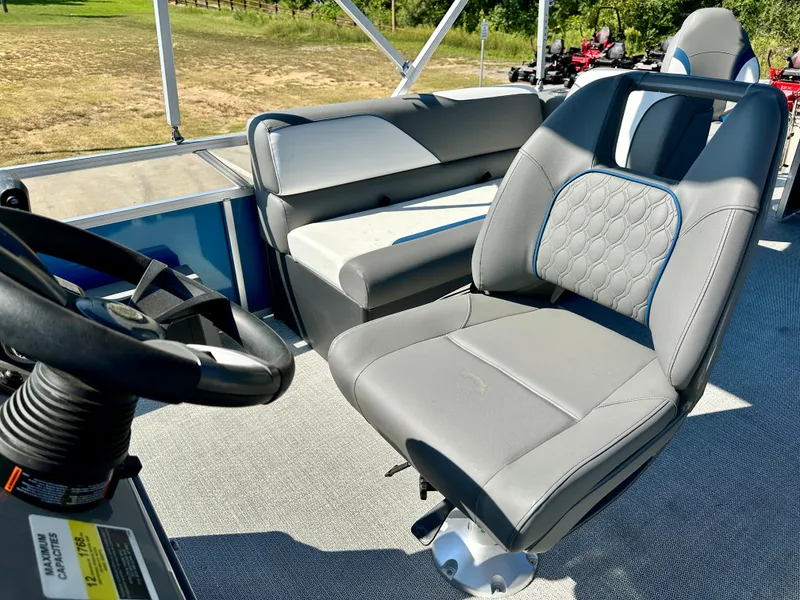 Slide: The Image of 2023 Tahoe Pontoon 23FT Sport 85 Center Console Fish boat interior with captain's chair and bench seat. - 7