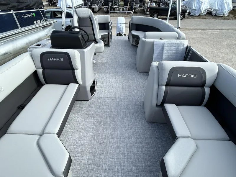 Slide: The Image of 2024 Harris Cruiser 190 pontoon boat interior with gray seating and spacious layout. - 12