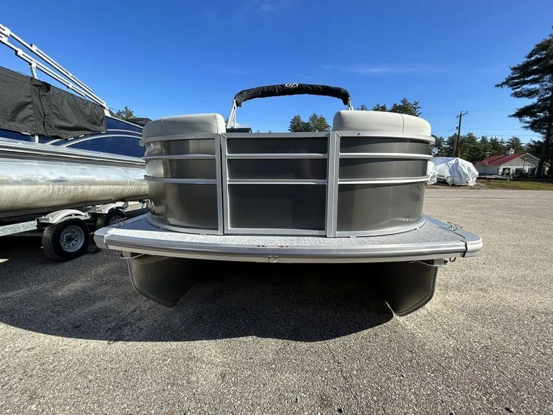 Slide: The Image of 2024 Harris Cruiser 190 pontoon boat, front view, parked on a sunny day. - 3