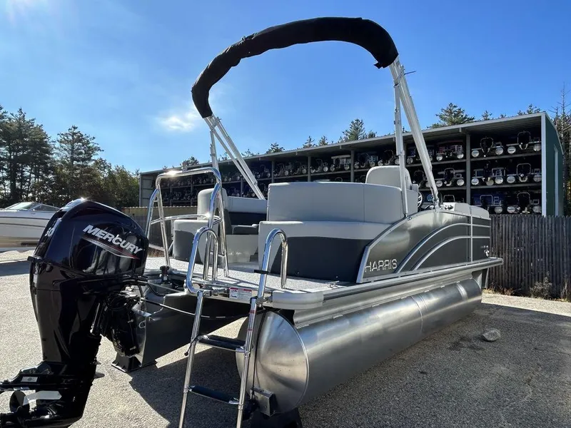 Slide: The Image of 2024 Harris Cruiser 190 pontoon boat with Mercury outboard motor in a marina. - 4