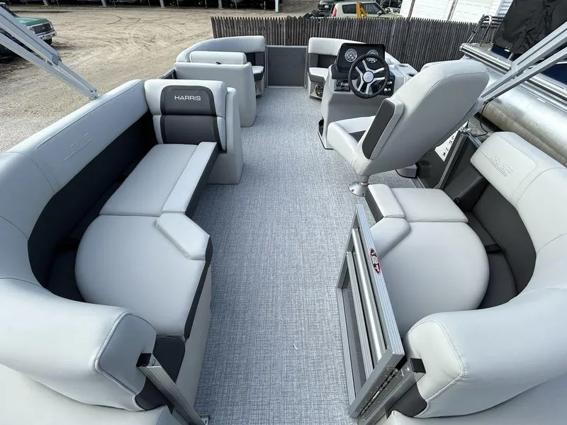 Slide: The Image of 2024 Harris Cruiser 190 pontoon boat interior with gray seating and modern helm. - 6