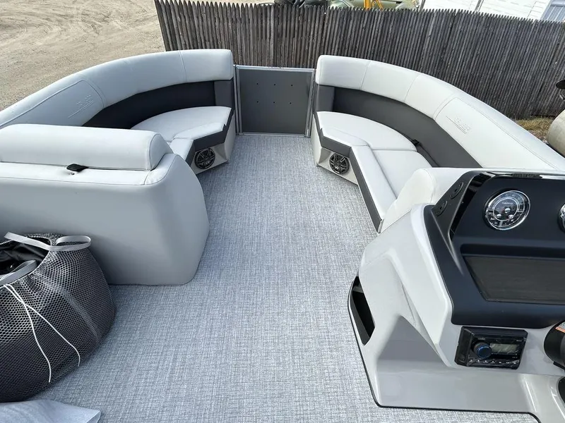 Slide: The Image of 2024 Harris Cruiser 190 boat interior with spacious seating and modern dashboard. - 8