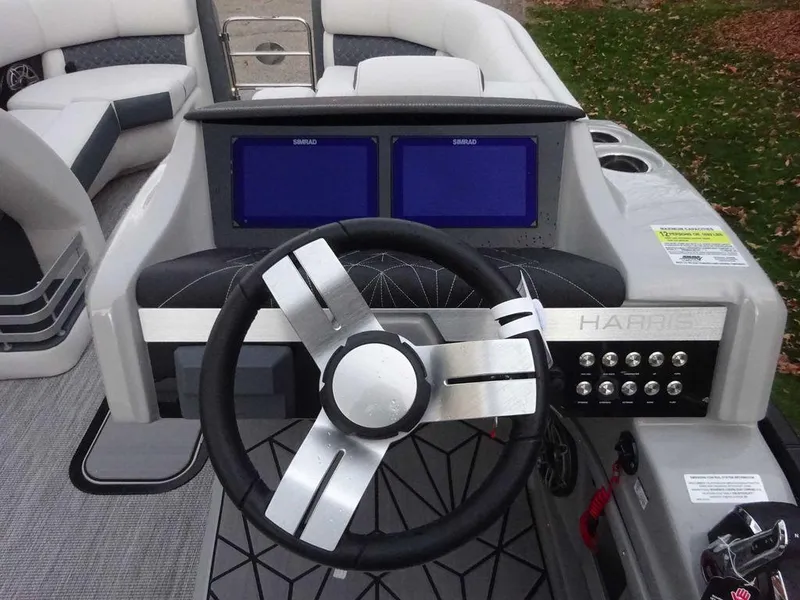 Slide: The Image of 2024 Harris Grand Mariner 230 dashboard with dual screens and modern steering wheel. - 6