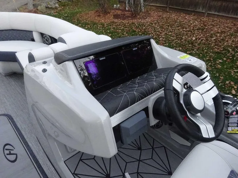 Slide: The Image of 2024 Harris Grand Mariner 230 dashboard with modern steering and dual displays. - 7