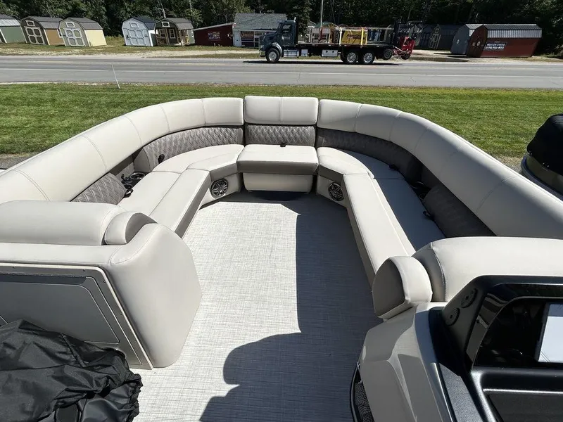 Slide: The Image of 2024 Harris Sunliner 230 pontoon boat with spacious seating and modern design. - 13